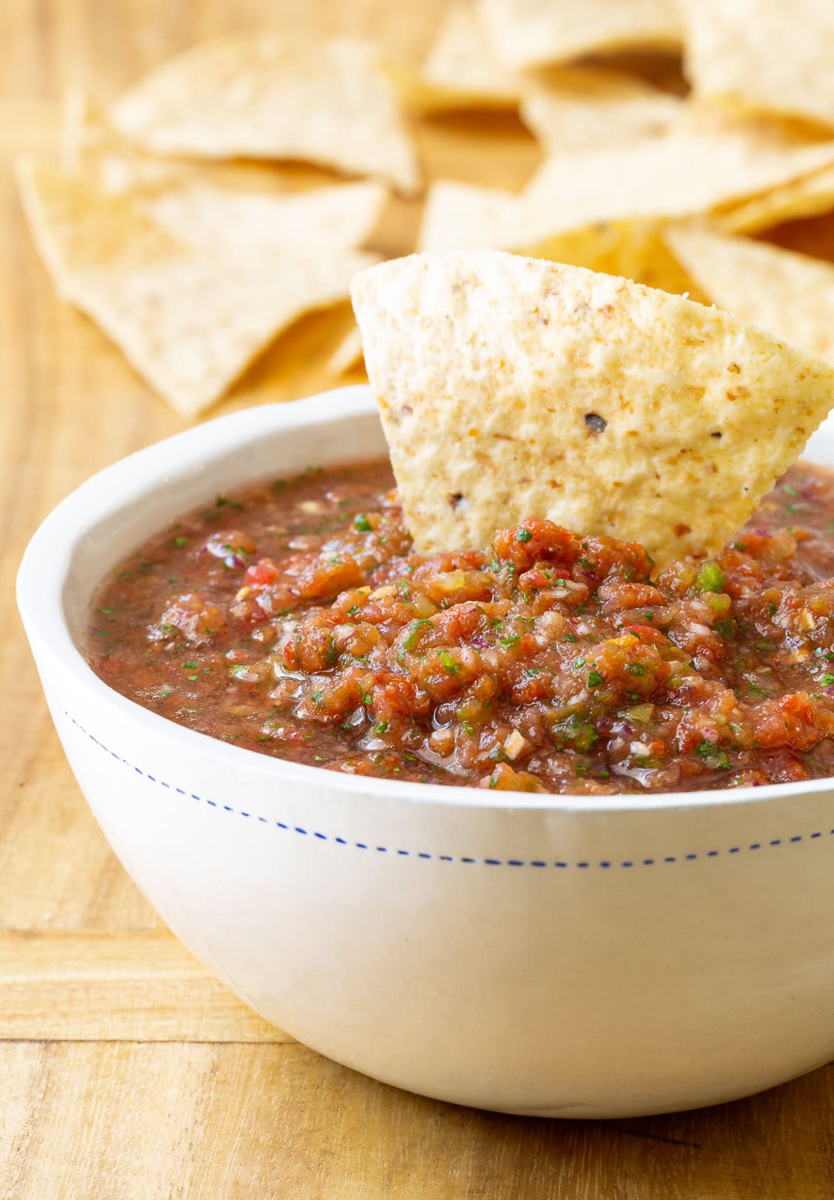 The Best Homemade Salsa Recipe shown in bowl with tortilla chips.