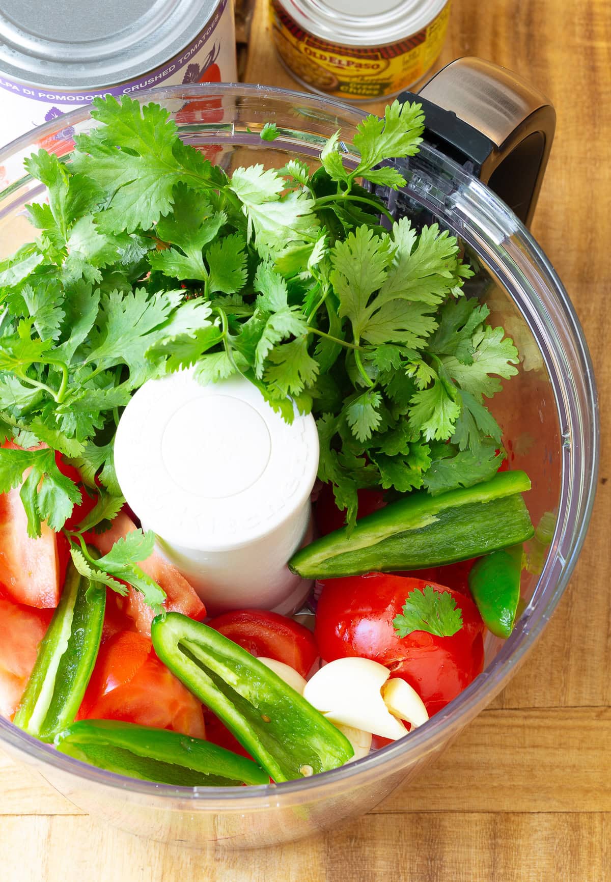 Ingredients for salsa in a food processor.