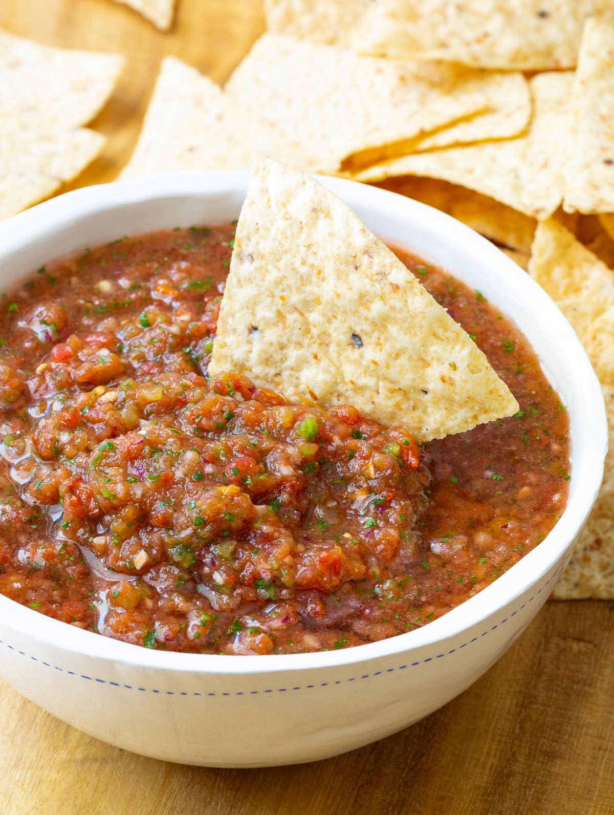 Close up of salsa in a bowl with tortilla chips for dipping.