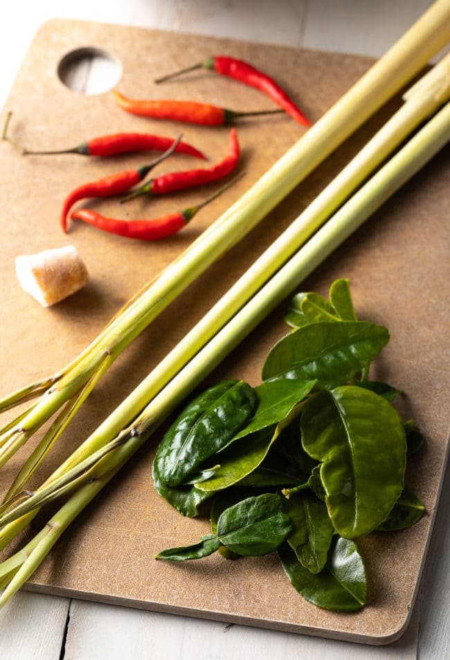 Ingredients for tom yum soup on a cutting board. 