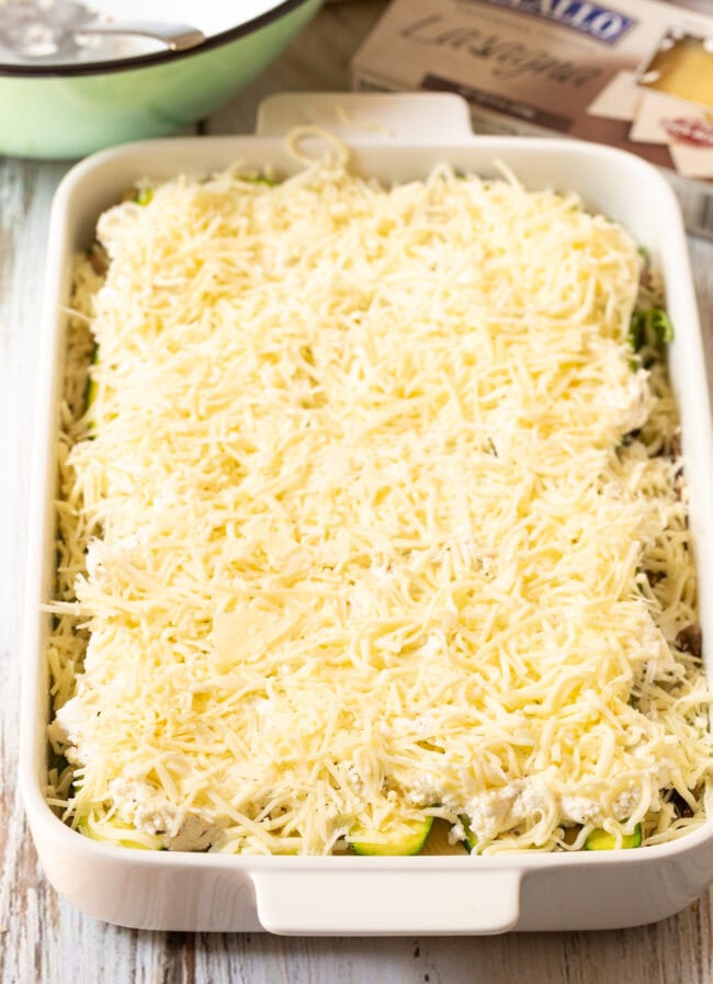 White vegetable lasagna assembled in a white baking dish before being baked. 