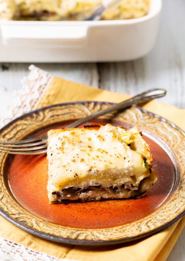 White vegetable lasagna assembled in a white baking dish before being baked. 