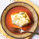 Vegetable lasagna with white sauce on plate