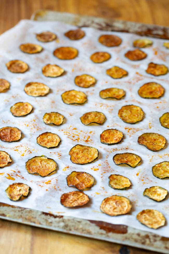 Oven Baked Zucchini Chips on cookie sheet with parchment paper